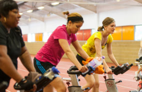 three women use the exercise bike at our Willesden gym